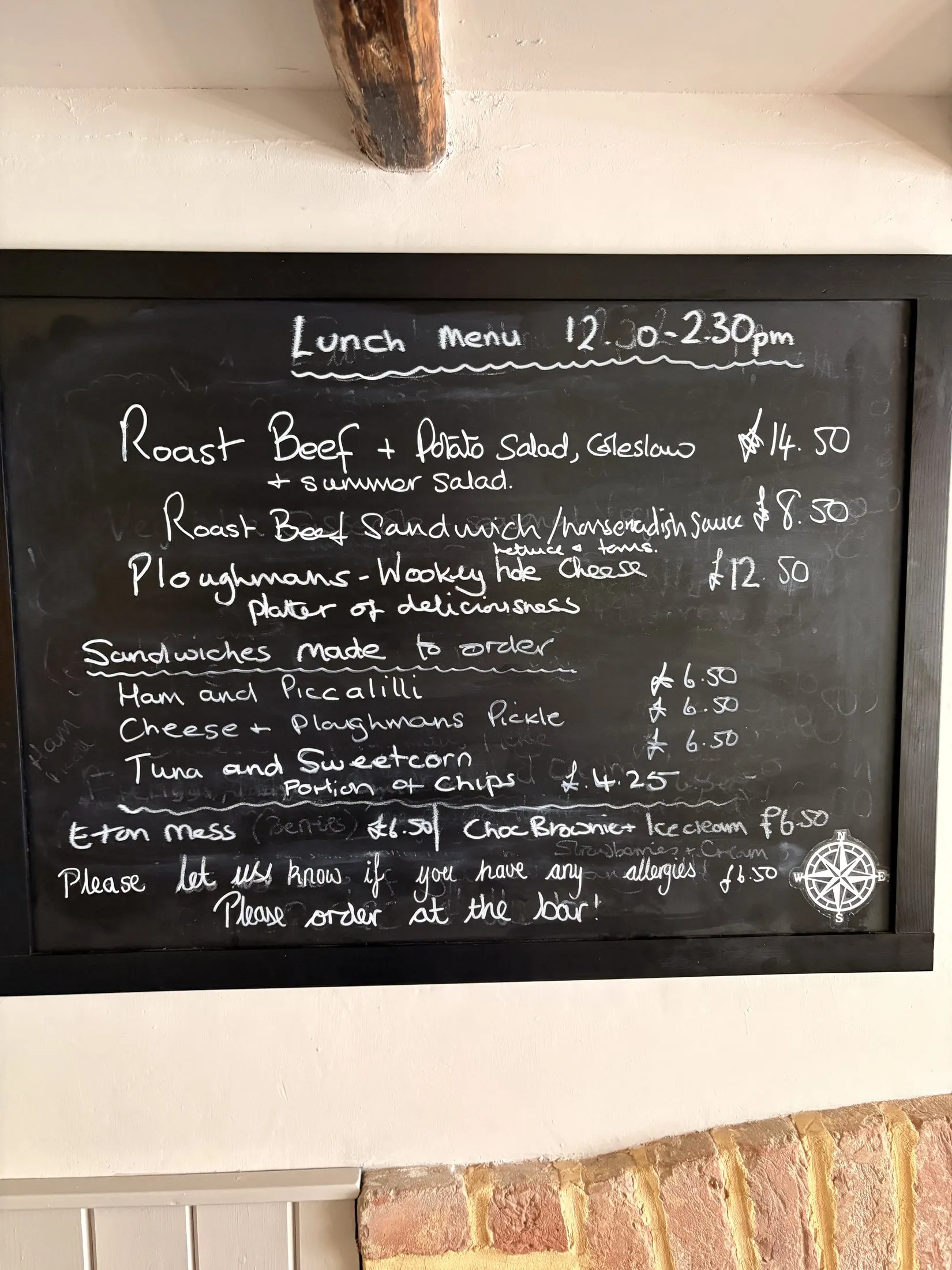 A chalkboard lunch menu with roast beef, ploughman's and freshly made sandwiches